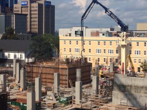 Placing arm pouring an elevator shaft wall.